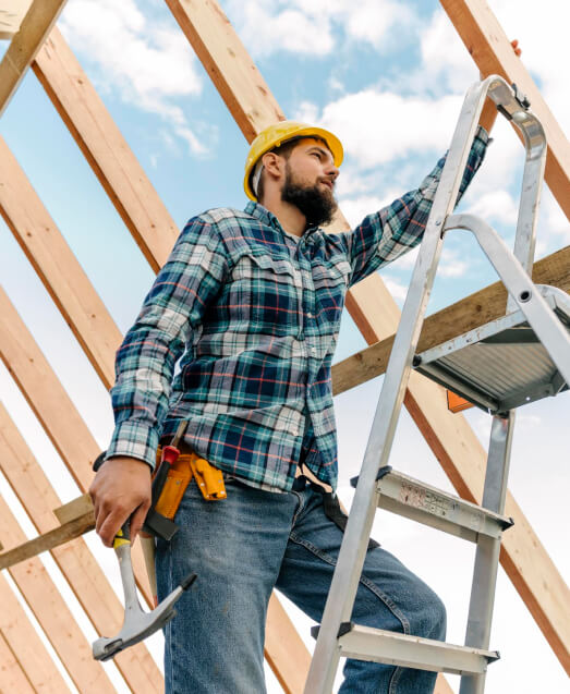 Roofing contractor happy because he has Roofing Contractor Small Business Insurance